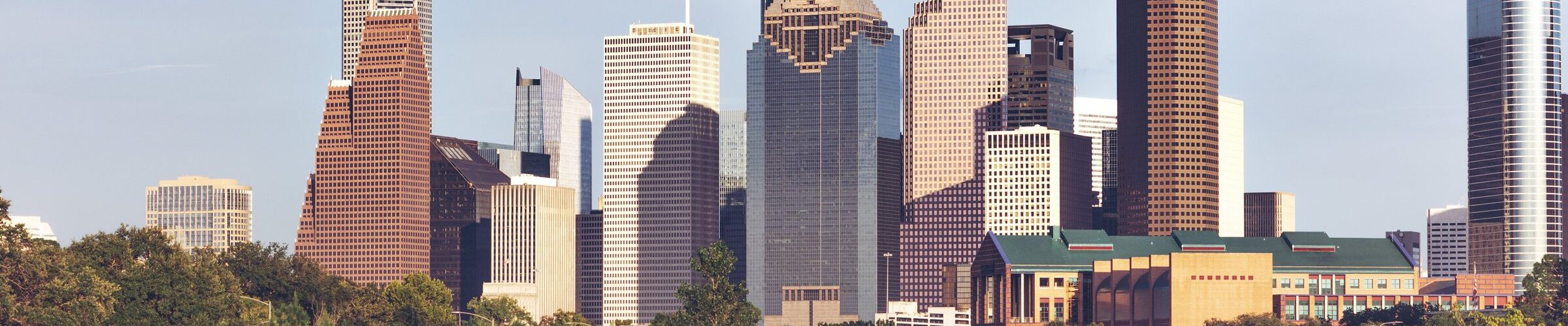 Les gratte-ciel du centre-ville de Houston au-dessus des arbres de Buffalo Bayou, en fin de journée